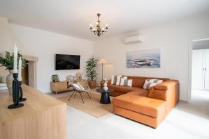 a living room with a couch and a table at Villa Kaia in Kringa