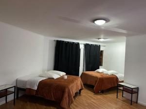 a room with two beds and a window at Hotel Atacama Copiapo in Copiapó