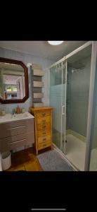 a bathroom with a shower and a sink and a mirror at GLAM in Saint-Jean-dʼArvey