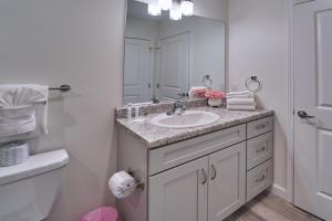 a bathroom with a sink and a mirror at The Ruby 303 By Avada Properties in Pigeon Forge