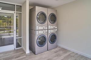 a laundry room with three washing machines in it at The Ruby 303 By Avada Properties in Pigeon Forge +11 photos