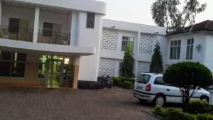 a white car parked in front of a house at Heritage Hotel in Trofwi