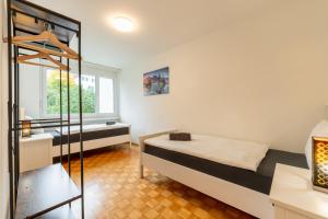 a bedroom with a bed and a tub in a room at Swiss Suites Oberrohrdorf in Rohrdorf
