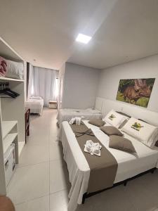 a hotel room with two beds in a room at Hotel Recanto dos Dinossauros in Penha