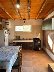 a kitchen with a table and a stove in it at El Rincon de las Marias in San Lorenzo +50 photos