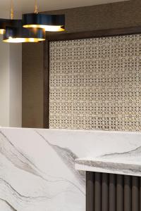 a kitchen with a white counter and a wall with a window at Hotel Rose in Rockford