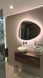 a bathroom with a sink and a mirror at L instant précieux in Marseille +5 photos