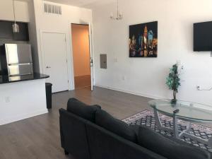 a living room with a couch and a glass table at Modern Leander Getaway Near Shop- Leander TX in Leander