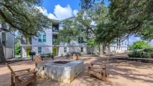 a fire pit in a park with two benches at Modern Leander Getaway Near Shop- Leander TX in Leander