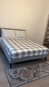 a bed in a room with a plaid mattress at Modern Leander Getaway Near Shop- Leander TX in Leander