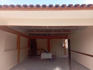 a room with a table and chairs in a building at Casa em Shangri-la próxima ao mar in Pontal do Paraná