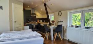 a kitchen with a bed and a table and chairs at Haus Königsstieg in Struckum