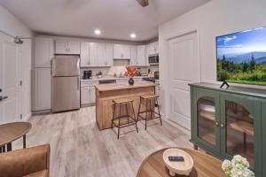 a kitchen with white cabinets and a large window at The Ruby 309 By Avada Properties in Pigeon Forge