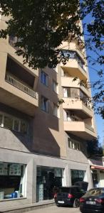 a tall building with cars parked in front of it at Apartment and Private Office in Yerevan