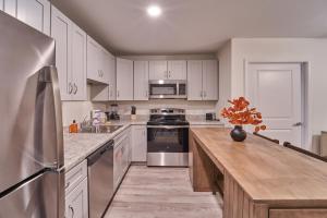 a kitchen with white cabinets and stainless steel appliances at The Ruby 310 By Avada Properties in Pigeon Forge