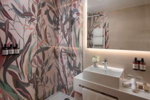 a bathroom with a sink and a mirror at NH Collection Milano Touring in Milan