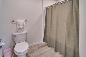 a bathroom with a toilet and a shower curtain at The Ruby 314 By Avada Properties in Pigeon Forge +14 photos