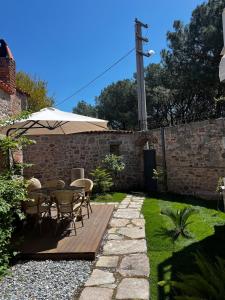 een tuin met een tafel, stoelen en een parasol bij No4Pergamon in Bergama +25 foto's
