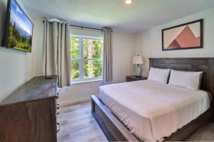 a bedroom with a large bed and a large window at The Ruby 315 By Avada Properties in Pigeon Forge