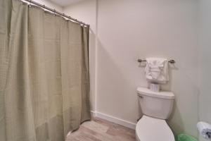 a bathroom with a shower curtain and a toilet at The Ruby 315 By Avada Properties in Pigeon Forge +14 photos