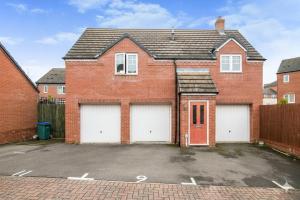 a red brick house with two garage doors at Modern Beautiful Luxury Coach House Free Parking in Birmingham