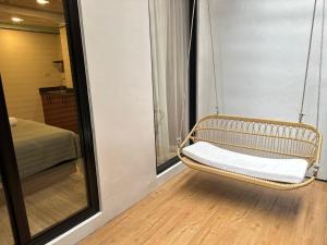 a swinging chair in a room with a mirror at Boutique hotel Axis Bangkok in Bangkok +21 photos