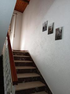 a staircase with pictures on the wall and a stair case at b&b s'antalena in Orgosolo +1 photo