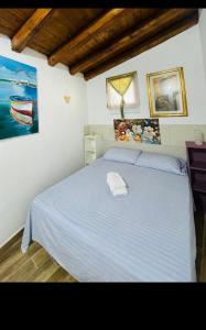 a bedroom with a bed with a towel on it at Villa Liliana Piroska in San Giuseppe Jato