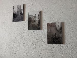 a wall with four pictures on a wall with aitivity at b&b s'antalena in Orgosolo