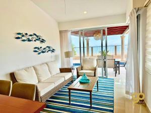 a living room with a couch and a table at Beachfront Compound, Pool, BBQ, Best for Groups in Refugio