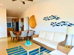 a living room with a couch and a table at Beachfront Compound, Pool, BBQ, Best for Groups in Refugio