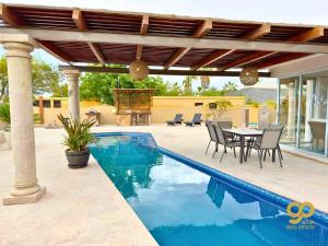 a patio with a table and chairs next to a pool at Beachfront Compound, Pool, BBQ, Best for Groups in Refugio +44 photos