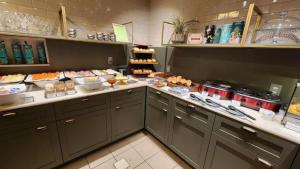 a kitchen with a bunch of food on a counter at Promenade Pancetti Belo Horizonte in Belo Horizonte