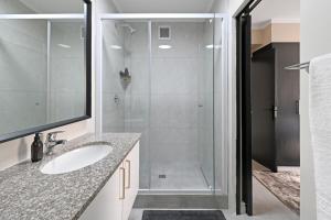 a bathroom with a shower and a sink at Soft Luxury 1BDR in trendy De Waterkant Nest in Cape Town +35 photos