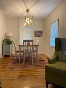 a dining room with a table and chairs and a couch at Midtown Cottage- Walk to Whole Foods in Tallahassee