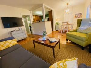 a living room with a couch and a coffee table at Midtown Cottage- Walk to Whole Foods in Tallahassee