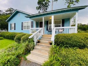 a blue house with a staircase in front of it at Midtown Cottage- Walk to Whole Foods in Tallahassee