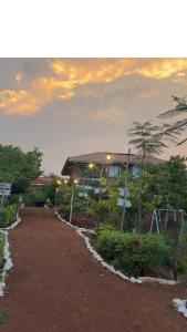 a road leading to a building with lights on at Chaloba Hills Agro Resort in Ajra