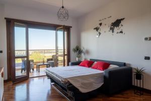 a bedroom with a bed with red pillows on it at appartamento con terrazzo vicino all'aeroporto di Fiumicino e alla fiera di Roma in Fiumicino Airport
