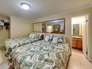 a bedroom with two beds and a mirror at Ocean Jewels Club 319 in Daytona Beach +17 photos