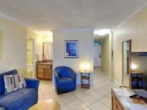 a living room with a couch and a blue chair at Ocean Jewels Club 319 in Daytona Beach