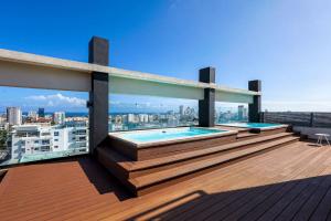 a balcony with two swimming pools on top of a building at Elegant and Cozy 1BD Condo in Ensanche Quisqueya