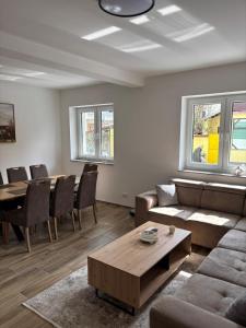 a living room with a couch and a table at White Quenn Apartments in Sanski most