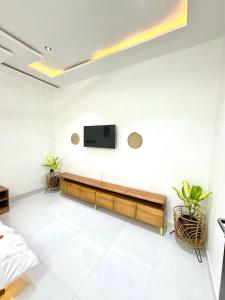 een woonkamer met een tv aan de muur bij Oaksvale Homes in Enugu