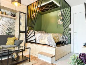 a bedroom with a bed inside of a room at Studio Oasis Emeraude in Saulx-les-Chartreux