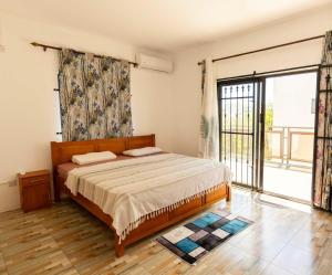 a bedroom with a bed and a large window at Hope Villa in Calodyne