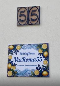 a sign on a wall with oranges on it at Via Roma 55 in Lipari