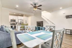 a dining room and kitchen with a table and chairs at Downtown Sea Escape in Pensacola