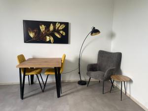 a dining room with a table and chairs and a lamp at Monstera III - industrial in Kolín