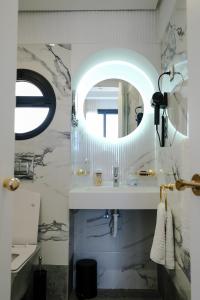 a bathroom with a sink and a mirror at Chic Hotel in Rabat
